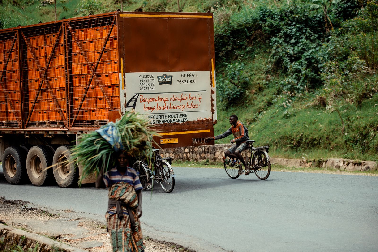 Freight truck on a rural West African road carrying goods inland along the trade corridor