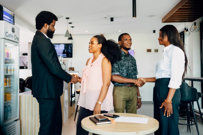 Business partners shaking hands during a meeting in Lagos, illustrating investment partnerships between DFIs and West African companies